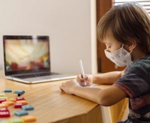 boy-wearing-medical-mask-attending-virtual-school