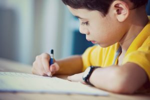 Young boy doing his homework in a home environment