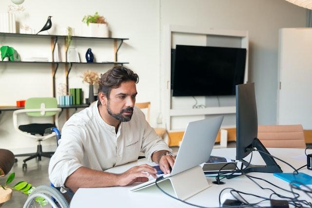 a-man-on-wheelchair-using-the-laptop