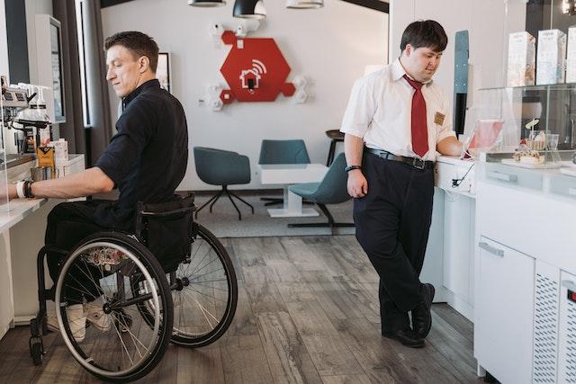 there-is-two-man-in-office-area-one-on-wheelchair