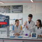 Students in a modern school chemistry lab using digital titration equipment to connect theoretical learning with real-world scientific practice.