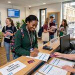 student registering at a modern GP reception